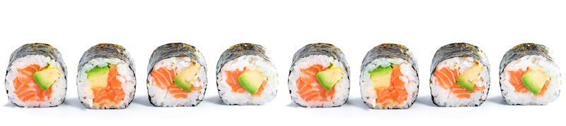 origin of sushi with traditional fresh japanese seafood sushi rolls on a white background