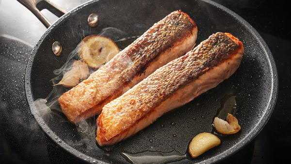 A photo of the proper cooking technique to achieve crispy fish skin