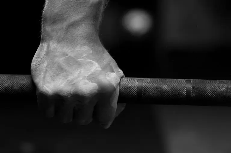 Closeup of male hand holding barbell