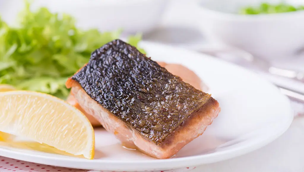 crispy fish skin on a grilled red fish fillet