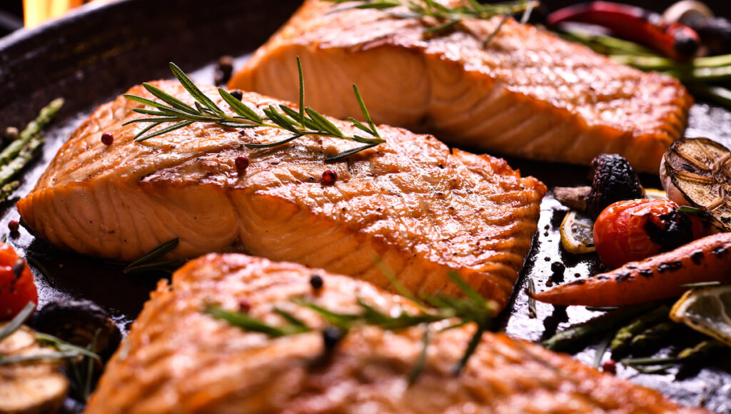 seafood grilling salmon fillets on a grill