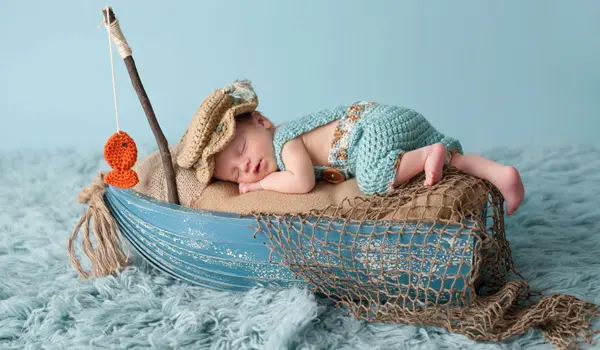 Photo illustration of a baby sleeping in a fishing boat