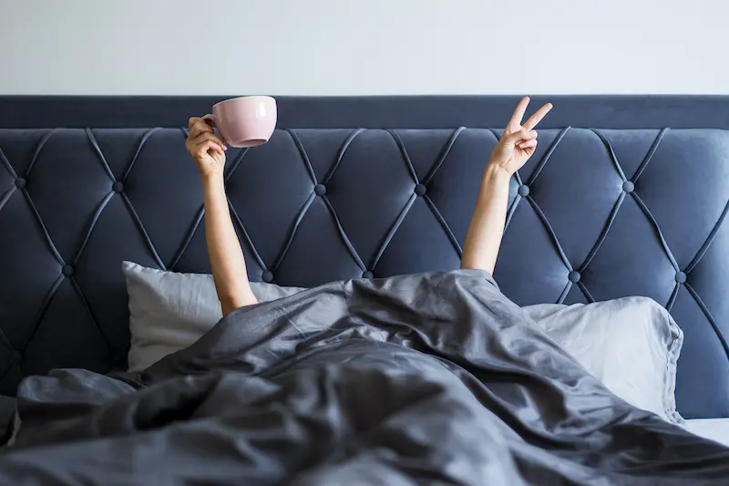 waking woman with coffee mug in hand