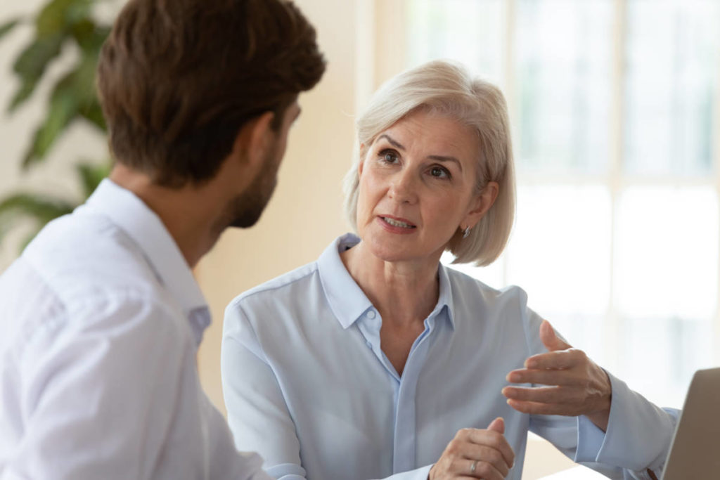 A photo of a difficult conversation between a young man and an older woman.