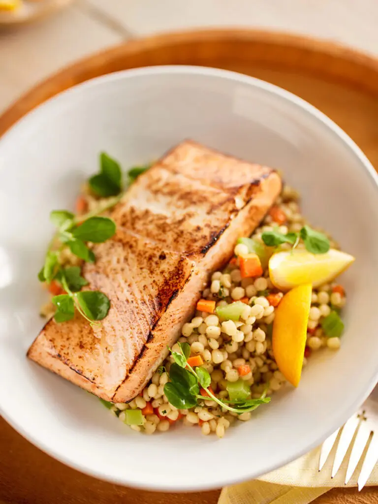 Omega-3 salmon in a bowl with rice and vegetables.