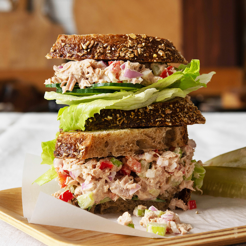 History of tuna fish sandwich with a tuna sandwich stacked.