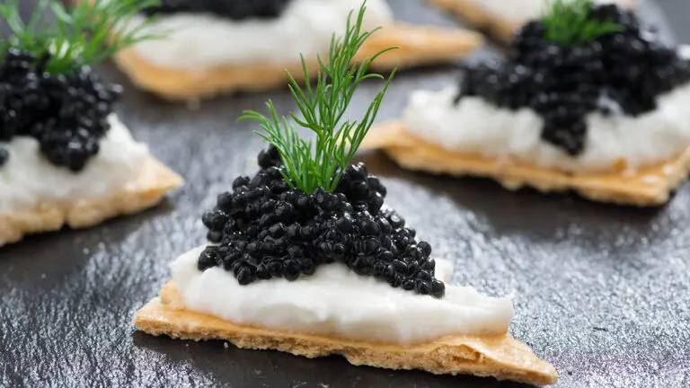 crackers with cream cheese and black caviar