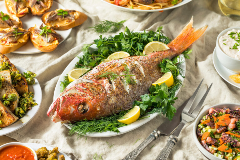 Feast of the seven fishes with fish dishes on a table.