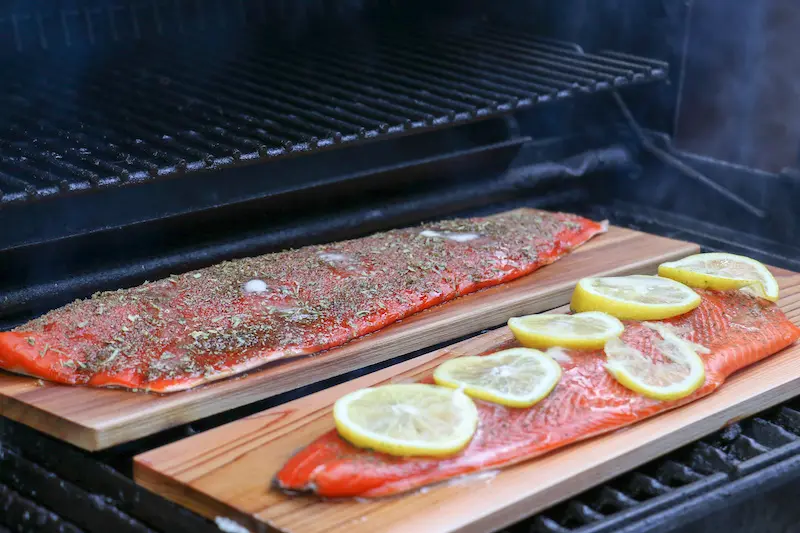 Cedar Plank Grilling showing salmon fillets on the grill.