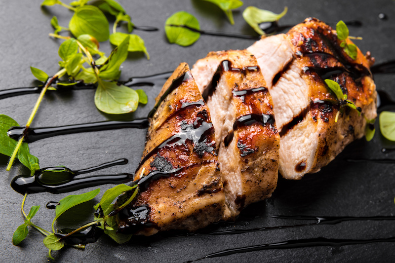 Balsamic vinegar recipes showing Roasted Chicken Breast on a Black Stone Plate with Balsamic Vinegar and Oregano