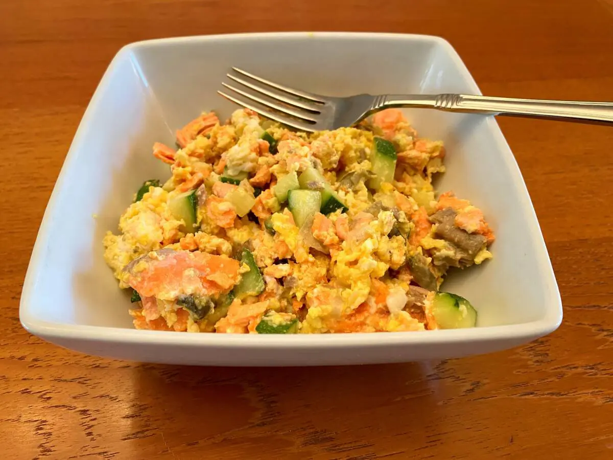 Salmon and eggs showing the finished dish in a white bowl.