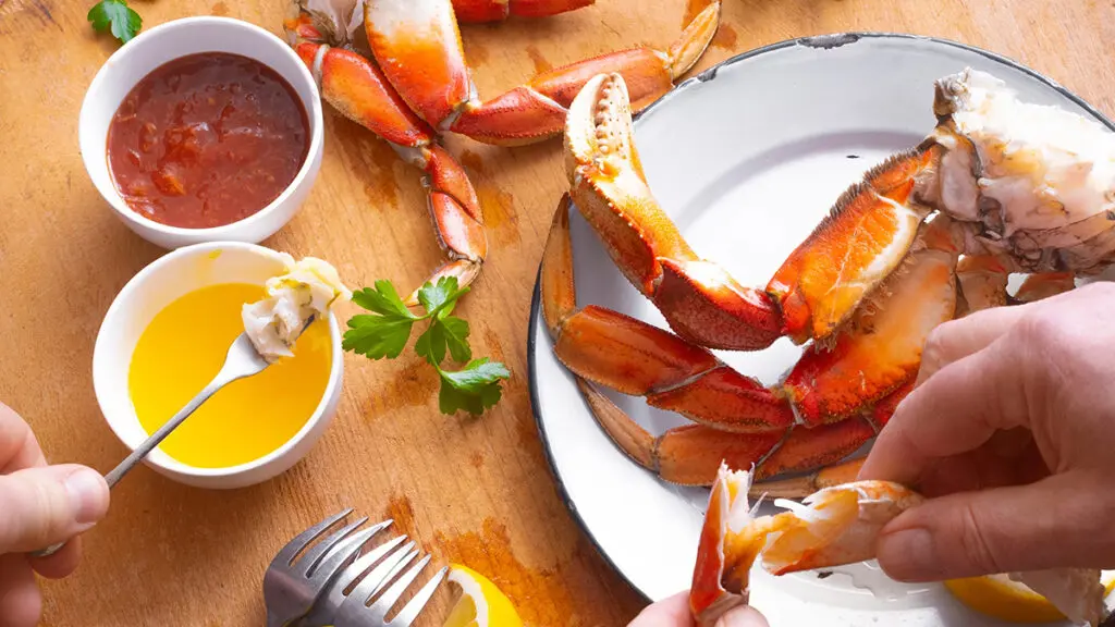 Seafood and vegetable pairings with a plate of crab and dip.