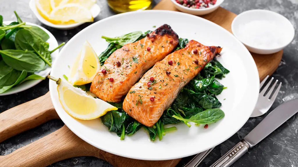Seafood and vegetable pairings with a plate of salmon and steamed spinach.
