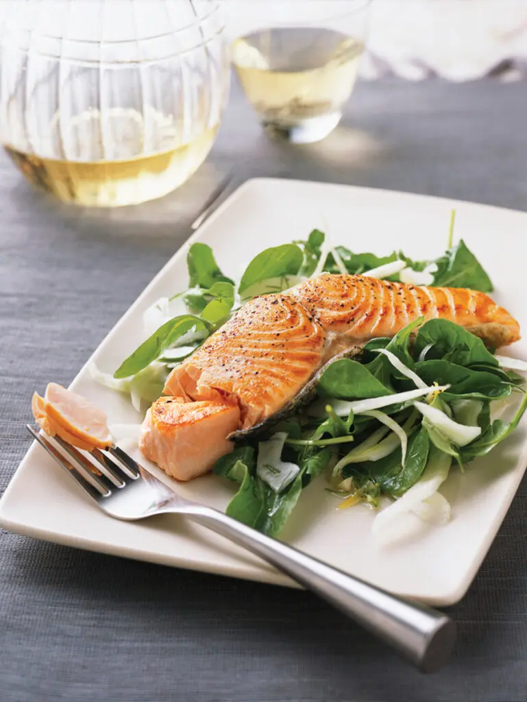 Salmon and spinach on a plate.