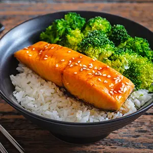 Fish recipes with a bowl of teriyaki salmon and broccoli.