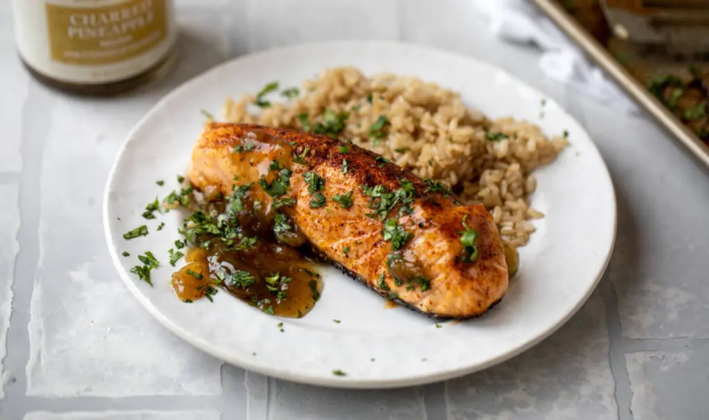 Grilled salmon on plate with rice.