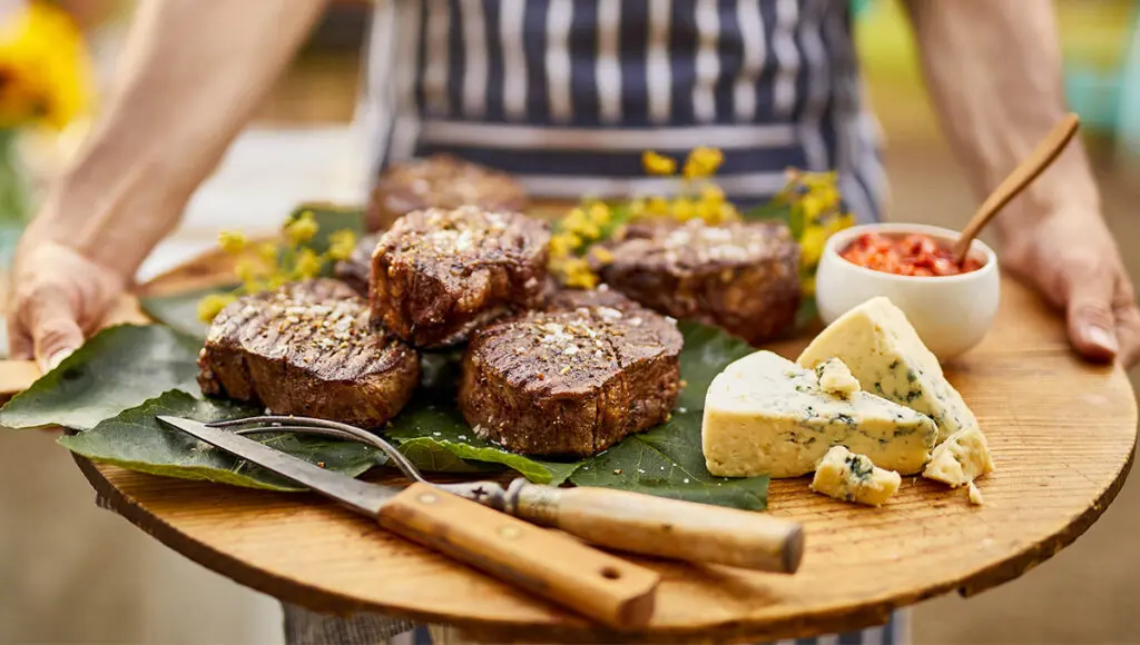 how to cook steak cooked steak with blue cheese on a board.