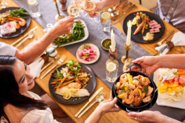 A group of people sitting at a table eating a pescatarian diet.