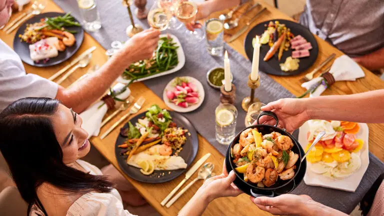 A group of people sitting at a table eating a pescatarian diet.