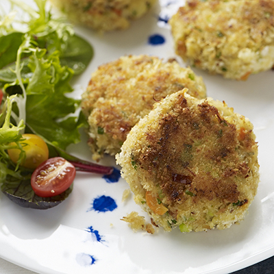 Seafood recipes with a plate of crab cakes and greens.