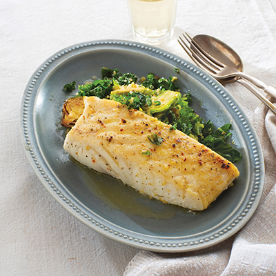 Seafood recipes with a plate of halibut and greens.
