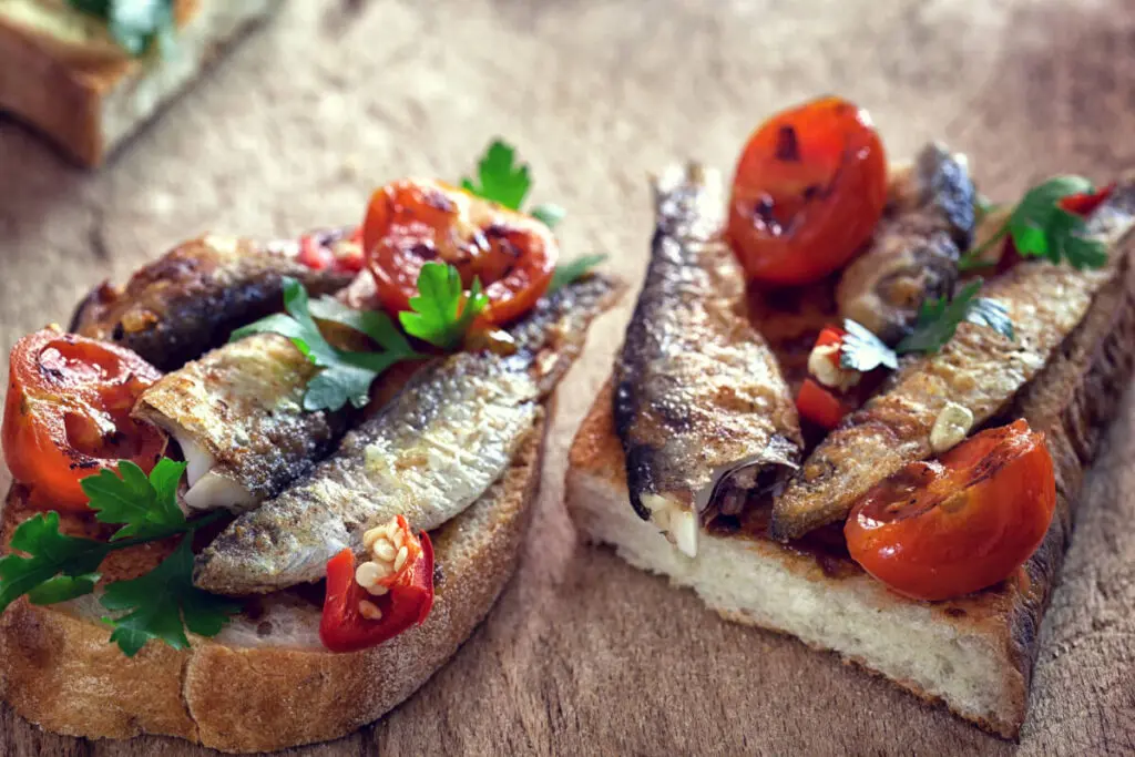 seafood tapas sardines and tomatoes on toasted bread