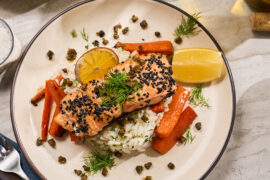 King salmon recipe with carrots and lemon on a plate.