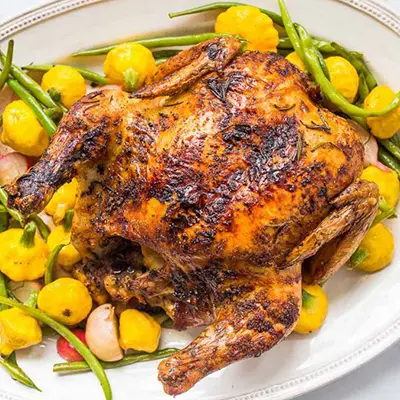 Roast chicken and vegetables on a plate.