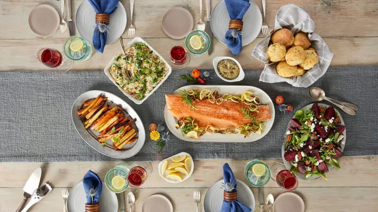 How to eat more fish with a table full of cooked fish, vegetables, and other food.