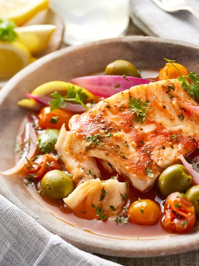 How to eat more fish with a bowl of fish, olives, and other items.