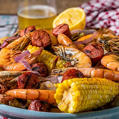Tailgating with fish with a seafood boil in a bowl.