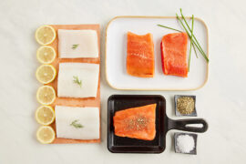 Cooking fish mistakes with several cuts of raw fish on platters with sliced lemon and other seasoning.
