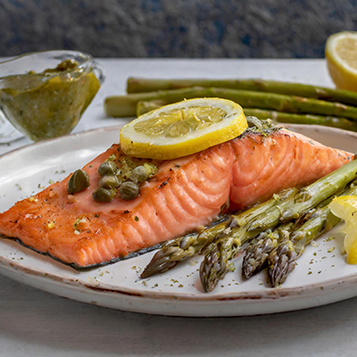Fish sauces with a plate of salmon with lemon caper sauce and asparagus.
