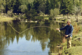 Presidents who love to fish with President Jimmy Carter casting a line into a lake.