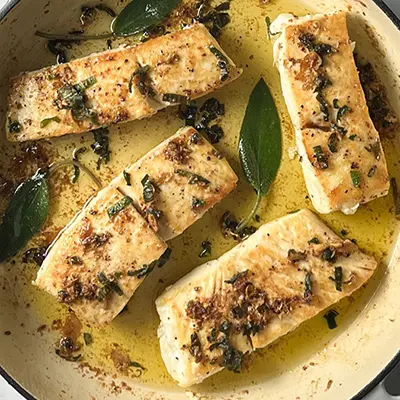 Copper River Seafoods halibut in a pan with butter and sage.