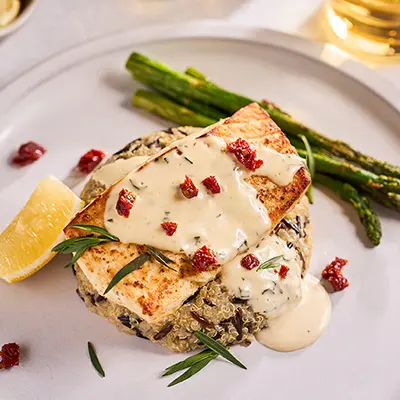 Easter fish recipes with a plate of broiled halibut topped with sauce.